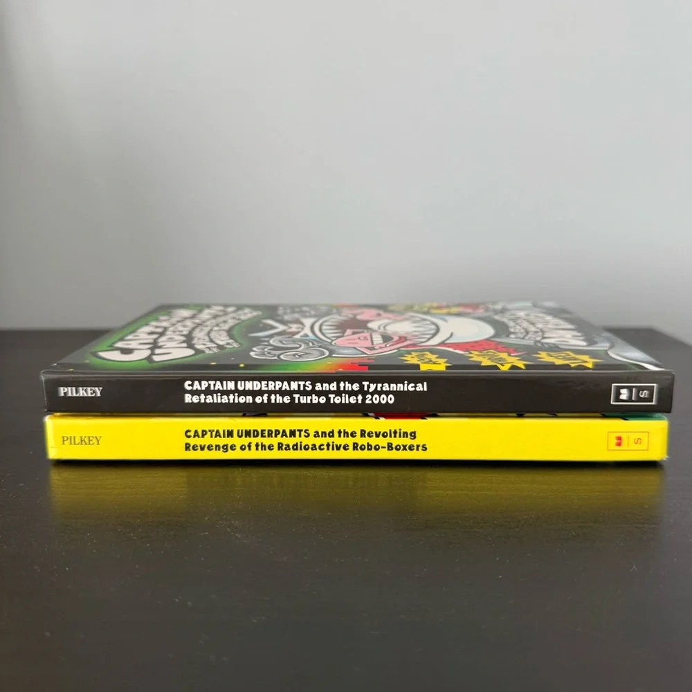 2 Captain Underpants hardcover books by Dav Pilkey. Tyrannical Revolting Revenge